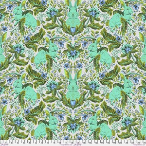 May include: A repeating pattern of teal bunnies in a white, green, and blue floral design. The bunnies are surrounded by leaves and flowers.