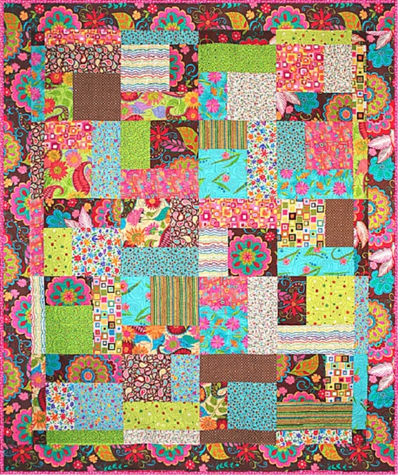 May include: A colorful patchwork quilt with a variety of floral and geometric patterns in shades of pink, green, blue, brown, and white. The quilt is made up of squares and rectangles of different sizes and is bordered with a pink and brown floral pattern.