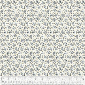 May include: Cream-colored fabric with a repeating pattern of blue leaves and small yellow dots. The leaves have a delicate, detailed design. A ruler is at the bottom, showing measurements in inches.