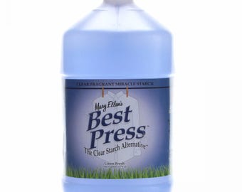 May include: A blue plastic gallon jug of Mary Ellen's Best Press Clear Fragrant Miracle Starch, a clear starch alternative. The label says "Linen Fresh" and "One Gallon (3.78 L)".