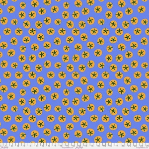 May include: A blue fabric with a repeating pattern of orange circles with green star-like designs inside. The fabric has a ruler printed along the bottom edge, with measurements in inches.