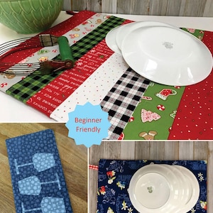 May include: A display of dish drying mats with the text "Dry Ideas" and "Beginner Friendly". The mats feature various patterns, including Christmas themes, gingham, and wine glasses. White plates and a green bowl are also present.
