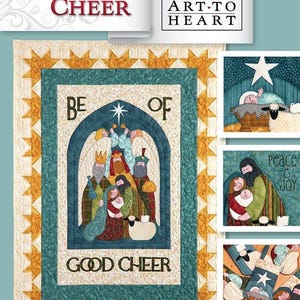 May include: A quilt pattern featuring a nativity scene with the words "Be of Good Cheer" in a blue and gold frame. The quilt pattern is from Art-to-Heart.