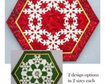 May include: Snow Dreams Tree Skirt or Table Topper sewing pattern featuring two designs in two sizes each. The pattern shows a red and white snowflake design and a green and white snowflake design.