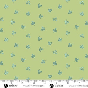 May include: A light green fabric with a repeating pattern of small blue floral sprigs. The fabric has a ruler along the bottom edge with the Andover Fabrics logo and website address.