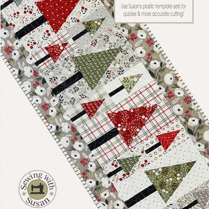 May include: A Christmas-themed table runner with a white background and a pattern of green and red Christmas trees. The runner is trimmed with a white floral border. The text "Fa la la Forest" and "18 1/2" x 45 1/2" are printed on the runner.