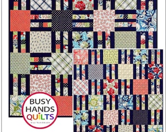 May include: A quilting pattern called "Picket Fence" featuring a colorful patchwork design with a navy blue background. The pattern includes 7 sizes and is fat quarter friendly. The pattern is designed by Myra Barnes for Busy Hands Quilts.