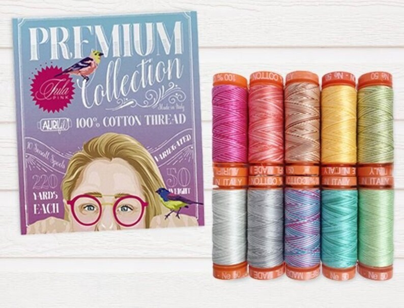 May include: A set of 10 spools of Aurifil 100% cotton thread in various colors, including pink, peach, yellow, and green. The spools are labeled "Aurifil" and "Made in Italy".