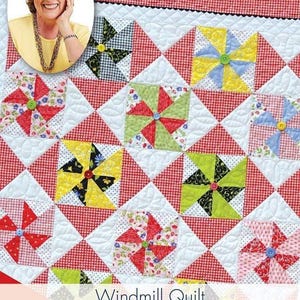 May include: A quilt pattern booklet with a red and white gingham background and a colorful windmill quilt design. The title is "Quilt in a Day® Easy" and the subtitle is "Windmill Quilt by Eleanor Burns". The text also says "Rotary Cutting or AccuQuilt Cutting".