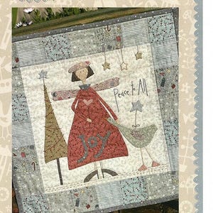 May include: A quilted wall hanging featuring a whimsical angel with a red dress and the word "Joy" on it. The angel is holding a bird with the words "Peace & Love" on it. The background is a patchwork of different fabrics in shades of blue, gray, and white. The text "Peace to All" is written in black on a white background.