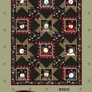 May include: A quilted wall hanging with the text "Baby It's Cold Outside!" features a repeating pattern of snowmen in various outfits. The quilt measures 46 inches by 62 inches. The design includes a black background with green and red accents.