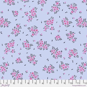 May include: A light blue fabric with a repeating pattern of small pink flower clusters. The fabric is shown with a ruler for scale.
