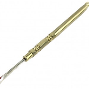 May include: A gold-colored metal threader tool with a small loop at the top and a sharp, pointed end. The tool is designed to help thread needles.