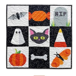 May include: A Halloween-themed wall hanging featuring nine squares with various spooky designs. Includes a bat, candy, tombstone, ghost, black cat, candy corn, pumpkin, bone, and a moth. The text "Frightful Minis" is at the top.