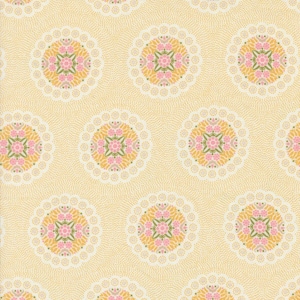 May include: A yellow fabric with a repeating pattern of pink and yellow floral medallions. The medallions are surrounded by a white lace-like design.