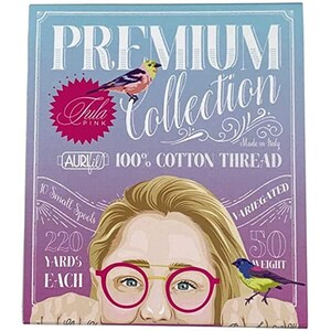 May include: A box of 10 small spools of 100% cotton thread, each spool containing 220 yards of thread. The thread is variegated and comes in a 50 weight. The box features a cartoon illustration of a woman with blonde hair wearing pink glasses and a bird perched on her finger. The box is labeled "Premium Collection" and "Aula Pink".