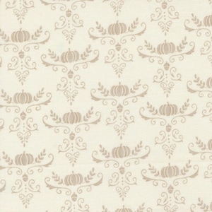 May include: Cream-colored fabric with a repeating pattern of pumpkins, leaves, and acorns in a light brown color. The design is symmetrical, with each pumpkin centered within a decorative flourish. The fabric has a subtle texture.