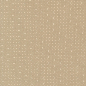 May include: Tan fabric with a repeating pattern of small white dots arranged in a diamond formation. The fabric has a slightly textured appearance, suggesting a woven material. The overall color is a warm, neutral tone.