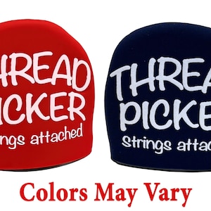 May include: Two thread pickers, one red and one blue, with the words "Thread Picker" and "Strings attached" printed on them.