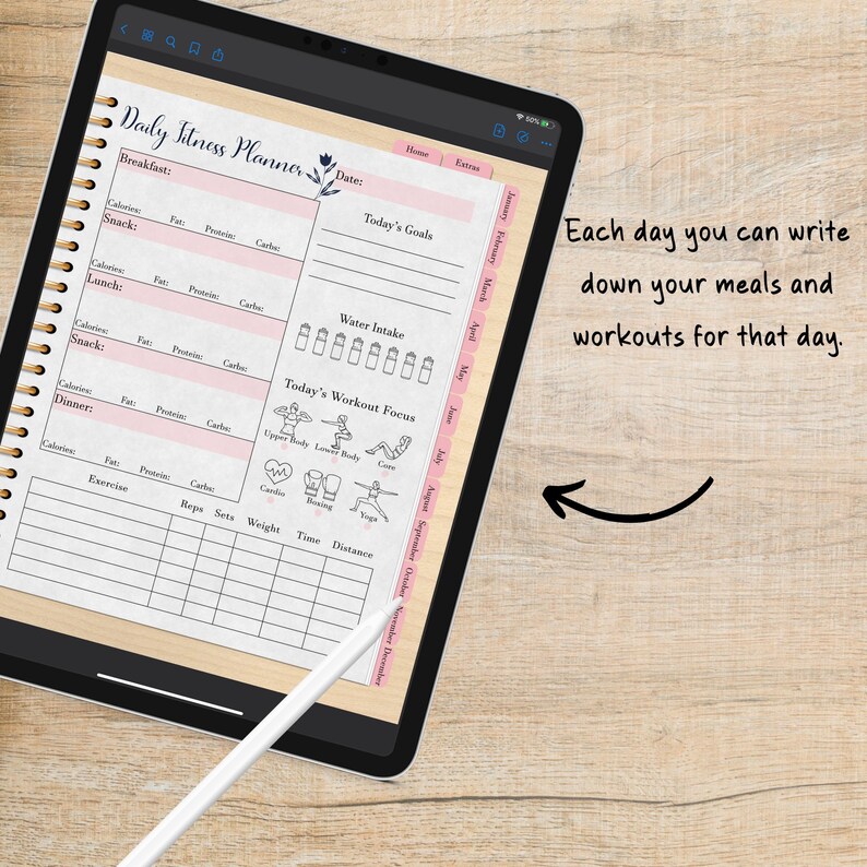 May include: A daily fitness planner on a tablet with a pink and white floral design. The planner includes sections for tracking meals, workouts, water intake, and goals. The tablet is on a wooden surface.