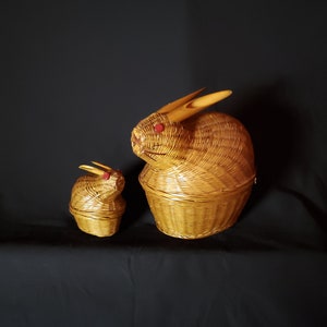May include: Two woven wicker rabbit baskets, one large and one small, with red eyes. The larger basket has long, pointed ears.