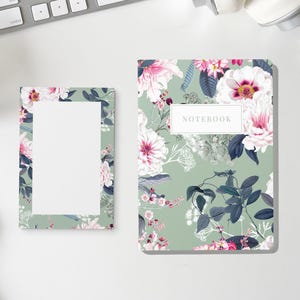 May include: A rectangular notebook and a smaller rectangular notepad, both featuring a sage green background with a floral pattern of white and pink flowers and dark blue leaves. The notebook has a white label with the text NOTEBOOK printed.