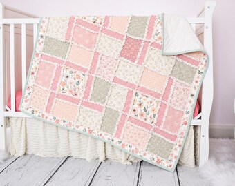 May include: A rag quilt featuring a patchwork design of rectangular fabric blocks in shades of sage green, soft pink, and cream. The quilt displays various floral and geometric patterns with frayed, exposed seams between each fabric square.