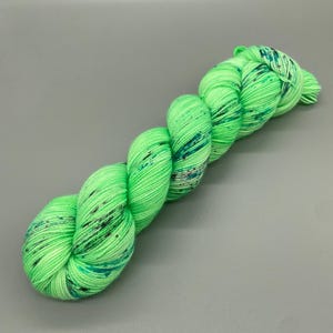 Hand Dyed Yarn, Superwash 75% Merino Wool, 25 Nylon Fingering, Bright Green base, Purple, Blue, Black Speckles - 463yds per skein