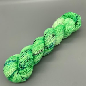 Hand Dyed Yarn, Superwash 75% Merino Wool, 25 Nylon Fingering, Bright Green base, Purple, Blue, Black Speckles - 463yds per skein