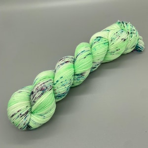 Hand Dyed Yarn, Superwash 75% Merino Wool, 25 Nylon Fingering, Bright Green and white base, Purple, Blue, Black Speckles - 463yds per skein