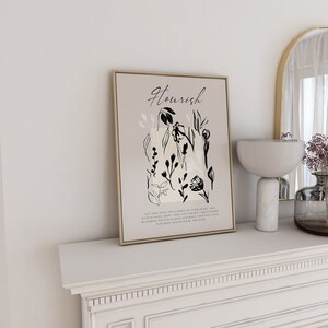 May include: A beige and black printable wall art print with a floral design and the text "Nourish". The text below the floral design reads "Let God tend the gardens of your heart, and watch faith, hope, and love impart, like flowers blooming with sunlight and rain, your soul will flourish and never be the same."