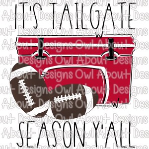May include: A red cooler with the text "IT'S TAILGATE SEASON Y'ALL" and two brown footballs. The cooler has black latches and a white outline. The footballs have white laces.