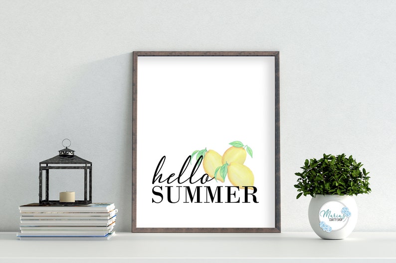 May include: A printable wall art design featuring a white background with the text "hello summer" in black script font. Three yellow lemons with green leaves are positioned above the text.