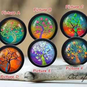 May include: Set of six round glass cabochons with black frames, each featuring a different colorful tree design. The trees are stylized and have different colors and patterns, including red apples, pink roses, orange citrus fruits, and swirling branches.