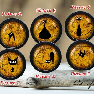 May include: Set of six black and white cat illustrations on round, yellow, gold, and brown cabochons with black frames. The cabochons are arranged in two rows of three. The illustrations feature cats in various poses, including sitting, standing, and lying down. The cabochons are perfect for crafting projects, such as jewelry, hair accessories, and keychains.