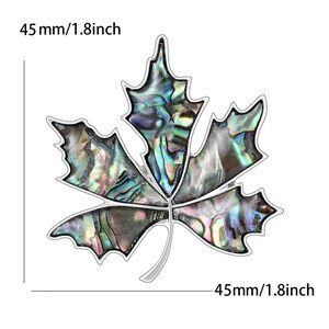 Peut inclure: Broche en forme de feuille d'&eacute;rable, 4,5 cm de large, avec un bord argent&eacute;. L'int&eacute;rieur de la feuille est en nacre iris&eacute;e, avec des nuances de vert, de bleu et de violet. La broche est munie d'une &eacute;pingle.