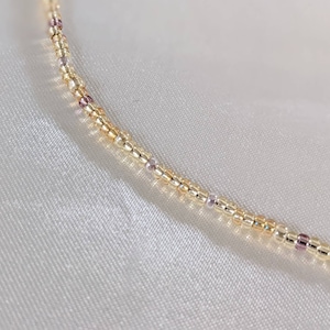 Gold bead necklace with tiny beads.