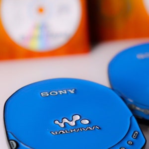 May include: A blue Sony Walkman CD player with a digital display and the text "WALKMAN" on the front.