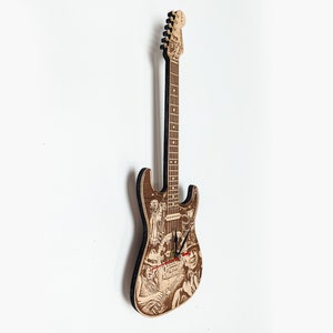 May include: A wooden electric guitar clock with a detailed design of a musical scene. The clock hands are red and black.