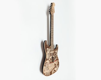 Puede incluir: Un reloj de madera con forma de guitarra eléctrica con un diseño detallado de una escena musical. Las manecillas del reloj son rojas y negras.