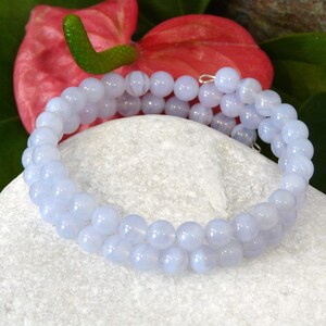 Op de afbeelding: Een armband met dubbele rij van lichtblauwe agaat kralen. De armband is gemaakt van gladde, ronde kralen en is lichtblauw.