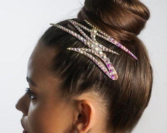 May include: A set of five gold hair combs with iridescent rhinestones. The combs are arranged in a fan shape and are designed to be worn in the hair.