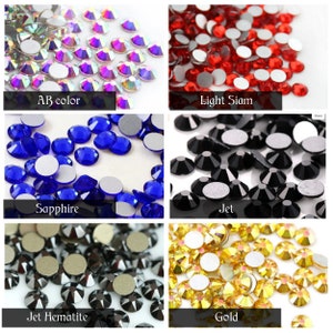 May include: Assortment of rhinestones in various colours, including AB colour, light Siam, sapphire, jet, jet haematite, and gold.