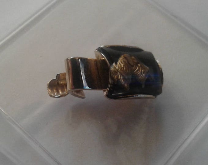 Small vintage tie clip with intaglio of Scottish Terrier in black and gold glass, Marked Hickok USA