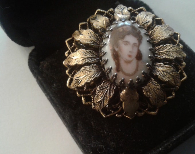 Vintage Porcelain Oval of Woman's Face in an Elaborate Goldtone Filigree Setting Brooch