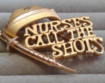 AJC Goldtone "Nurses Call The Shots" Pin with Cap and Hypodermic, Signed