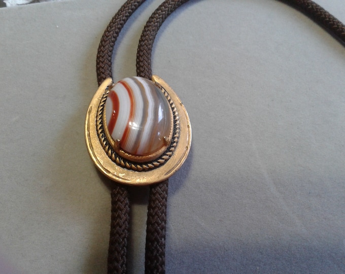 Banded Agate and Goldtone Metal Horseshoe and Brown Cord Bolo Tie