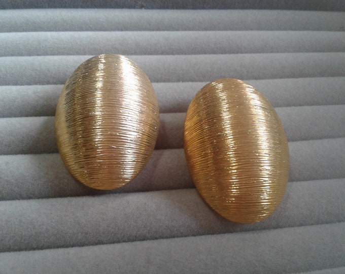 Oversized textured oval gold tone clip on earrings