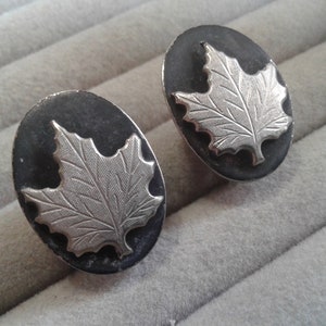 Silvertone and Black Painted Metal Maple Leaf and Oval Clip On Earrings