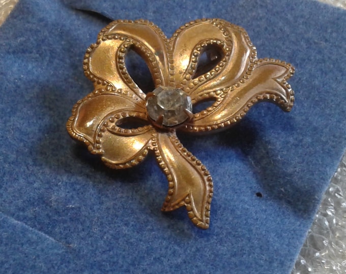 Very Small Stamped Metal and Rhinestone Antique Bow Pin
